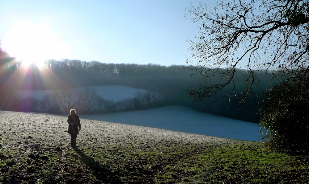 person standing on hill during daytime