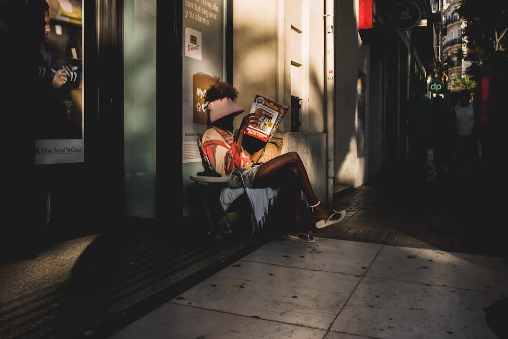 person sitting on chair holding book