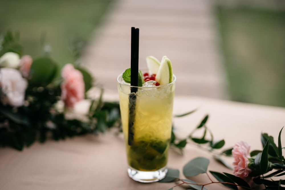 pint glass near flowers on table