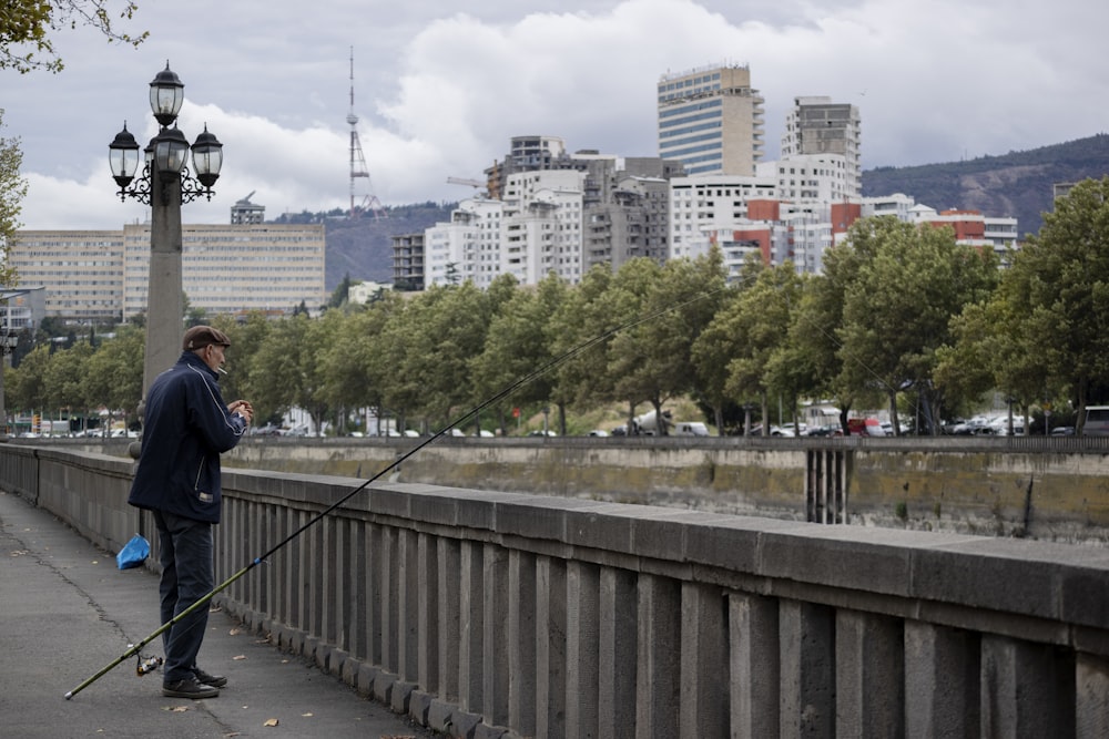 man standing beside railing