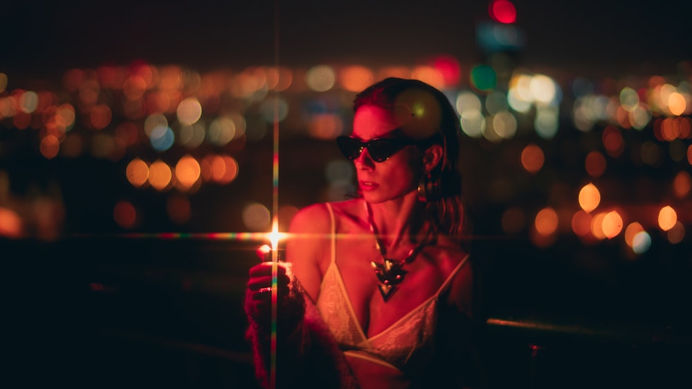 woman holding lighter at night