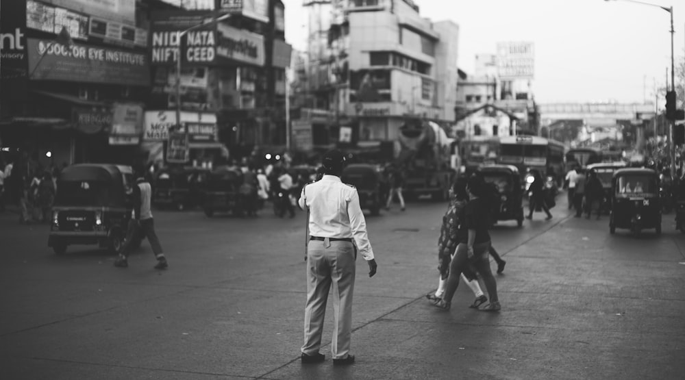 greyscale photo of people on street