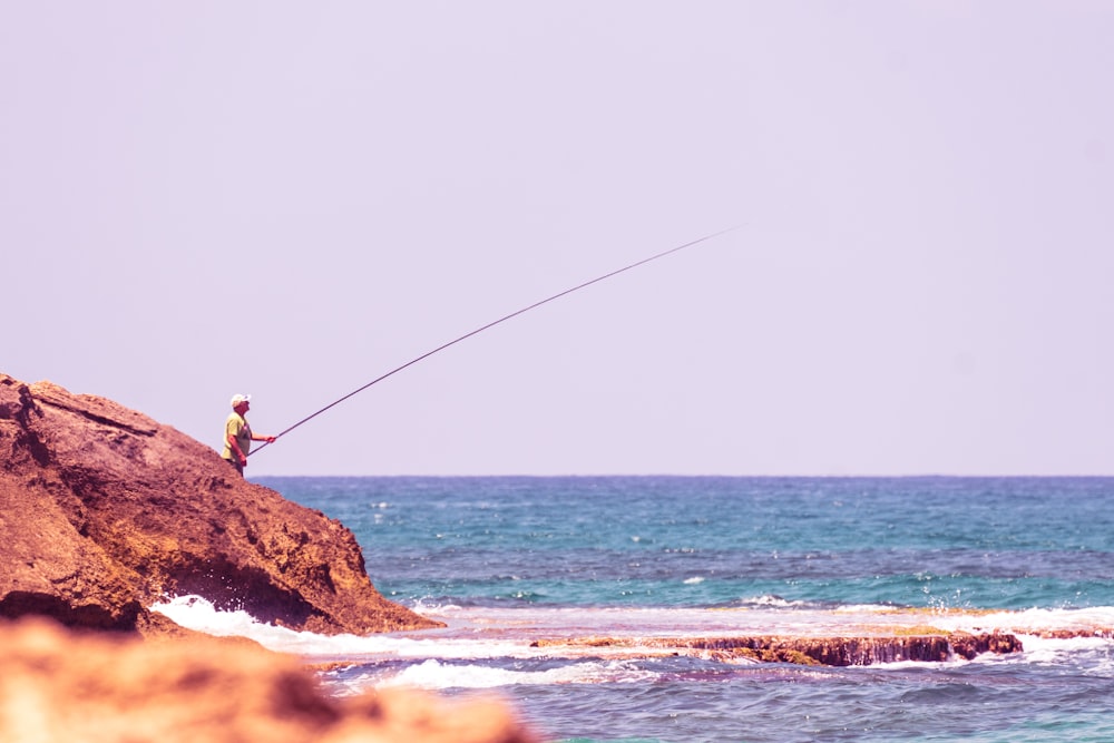 person fishing in body of water during daytime