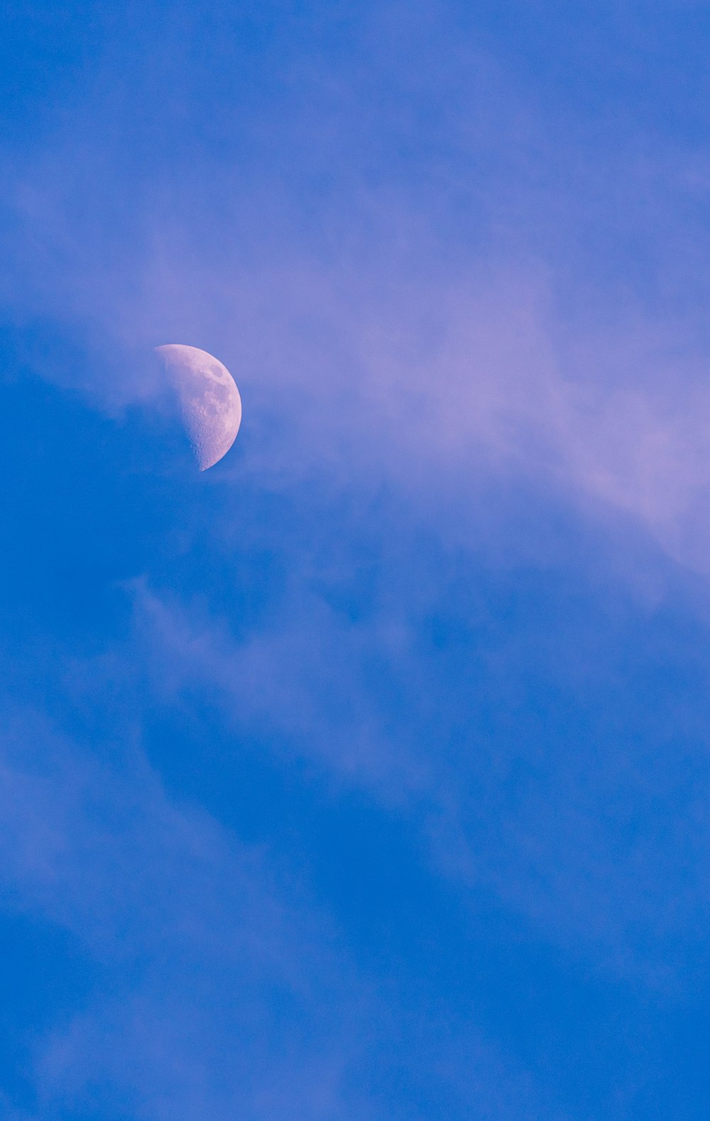 white clouds and half moon