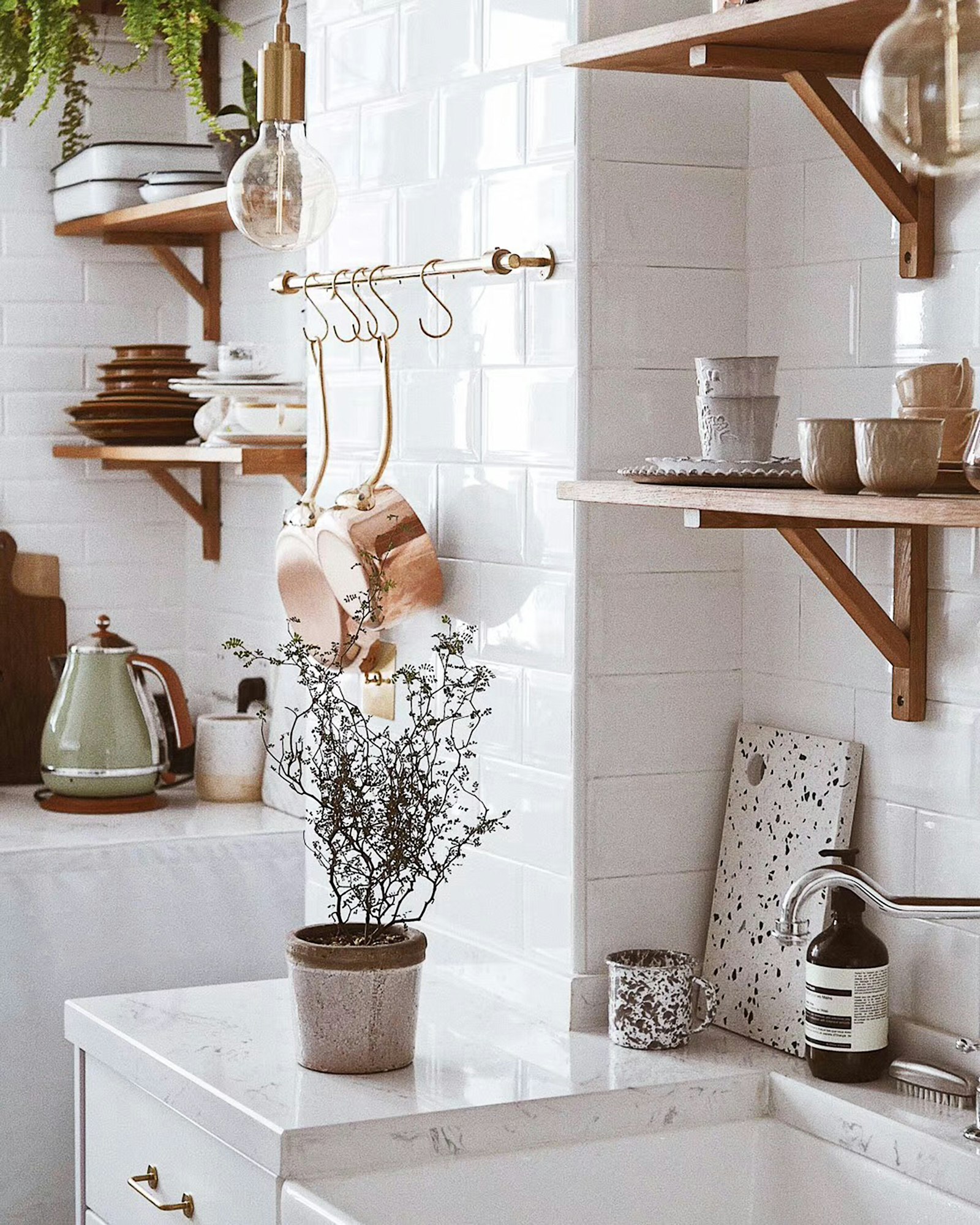 A fresh, bright Scandinavian kitchen with wood and greenery