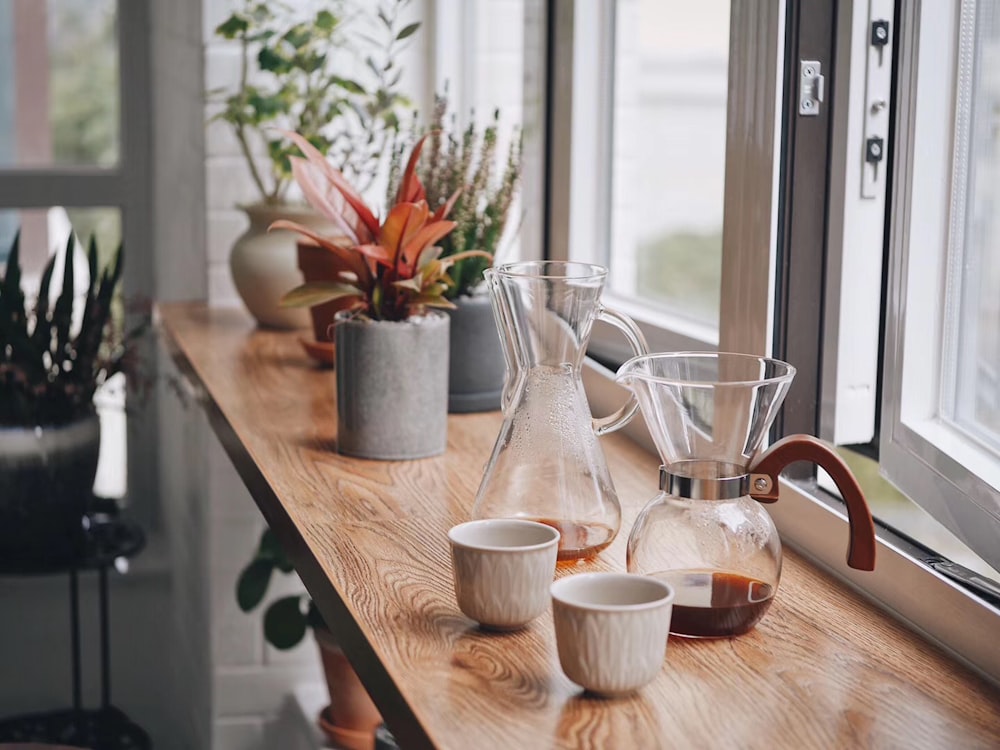 two empty glass pitcher and carafe near open table