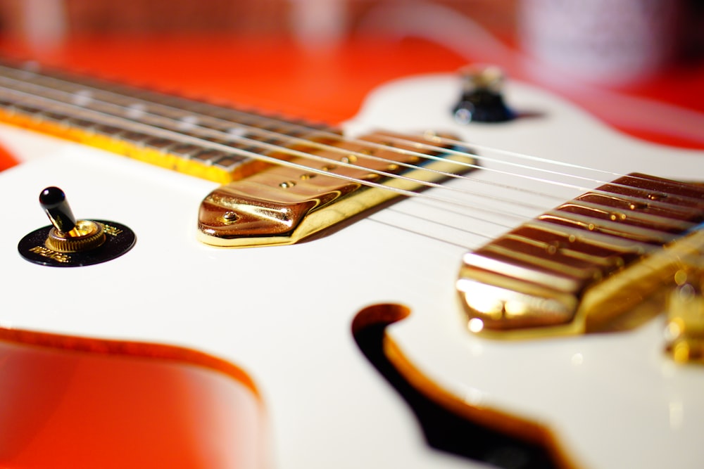 white and red electric guitar