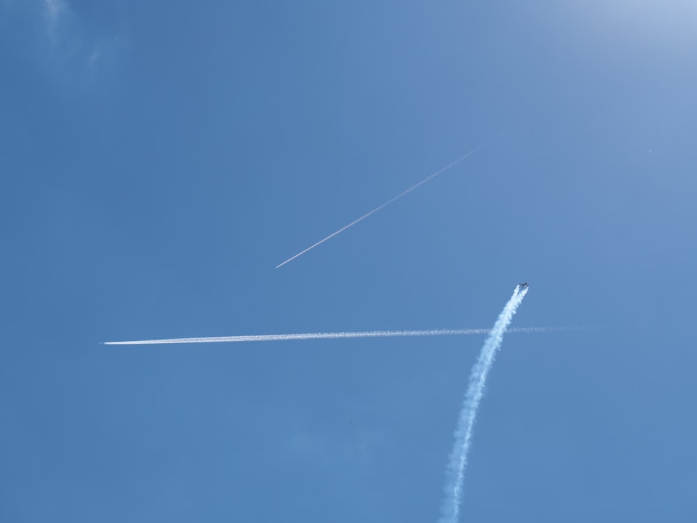 three contrails at daytime