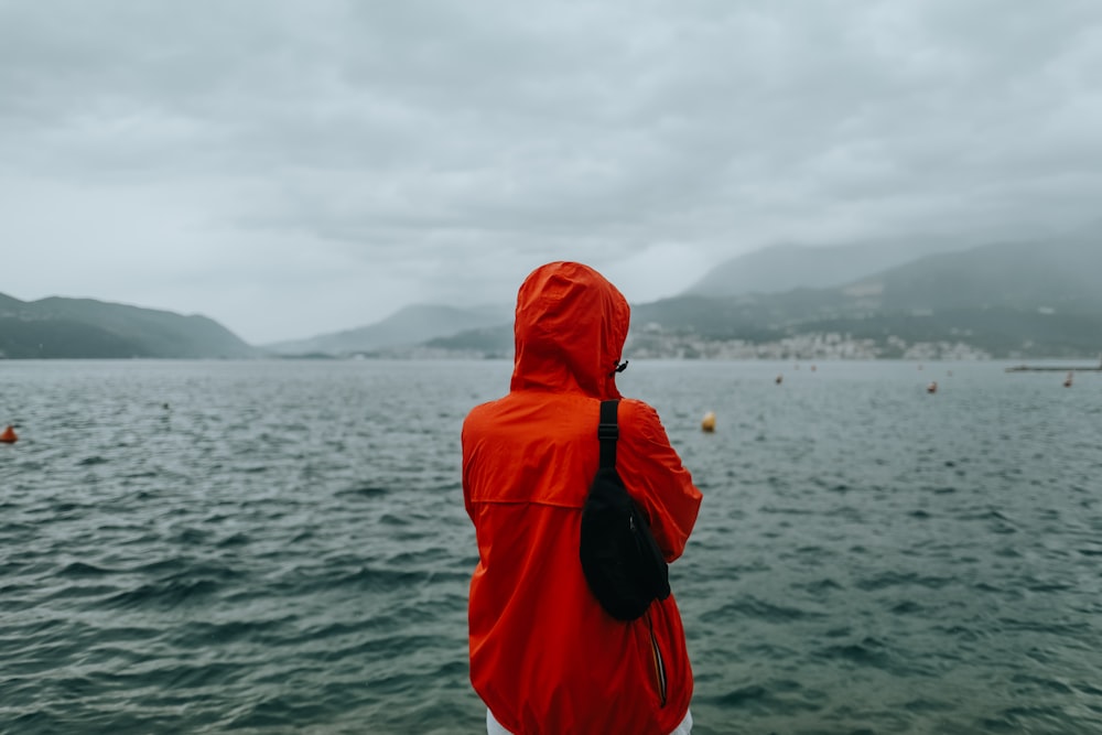 person standing beside body of water during daytime