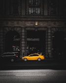 yellow sedan in a road during daytime