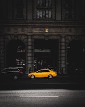 yellow sedan in a road during daytime