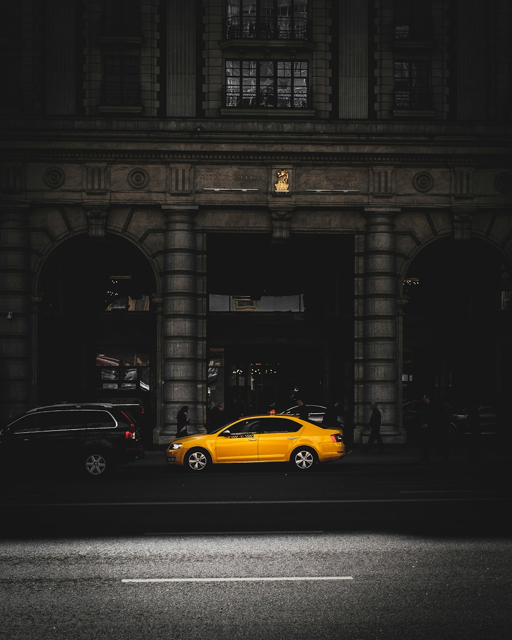 yellow sedan in a road during daytime