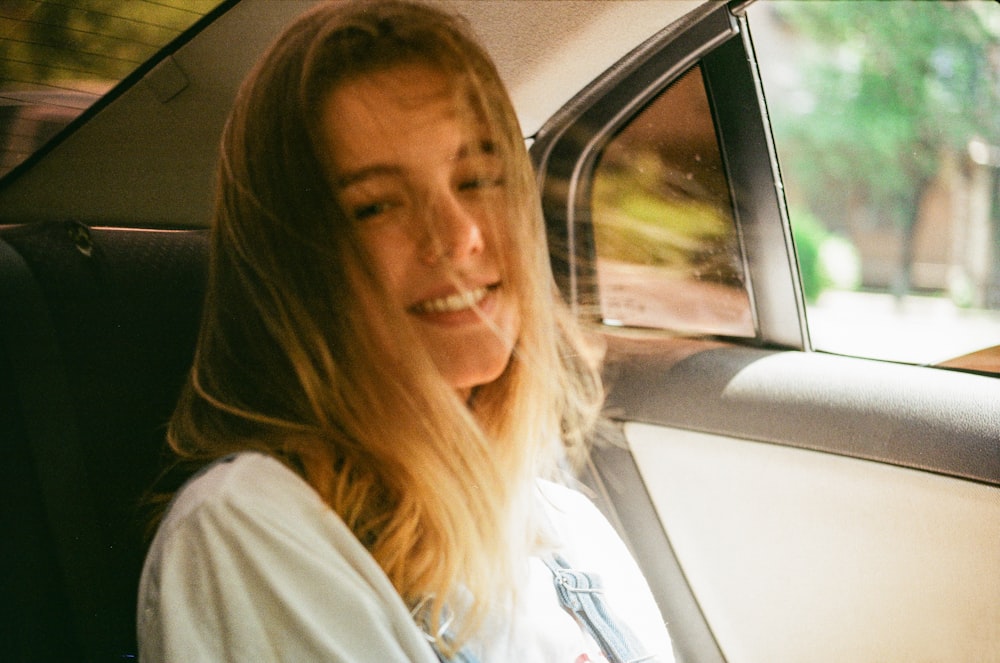 woman sits at the back of the driver's seat