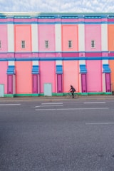 A vibrant building facade being painted by professionals.