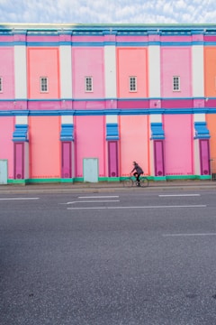 A vibrant building facade being painted by professionals.