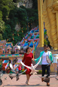 A family happily exploring a Thai temple, representing family visa success.