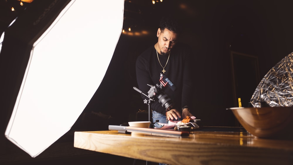 man standing beside table