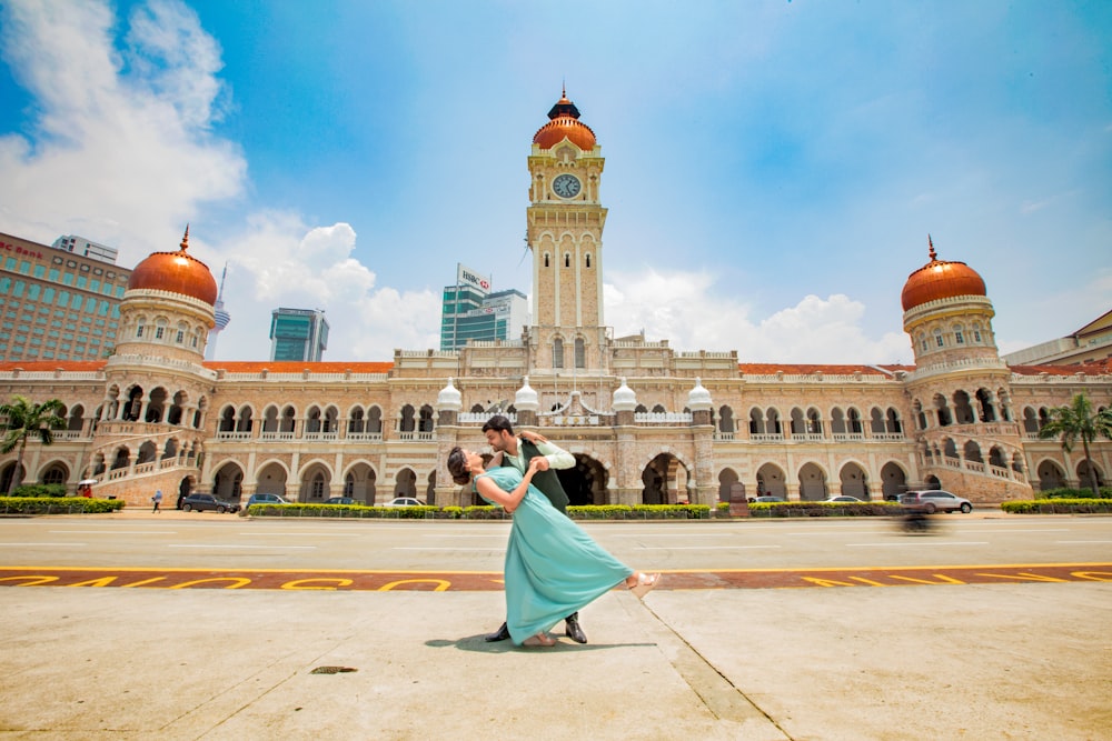 man and woman dancing near building]