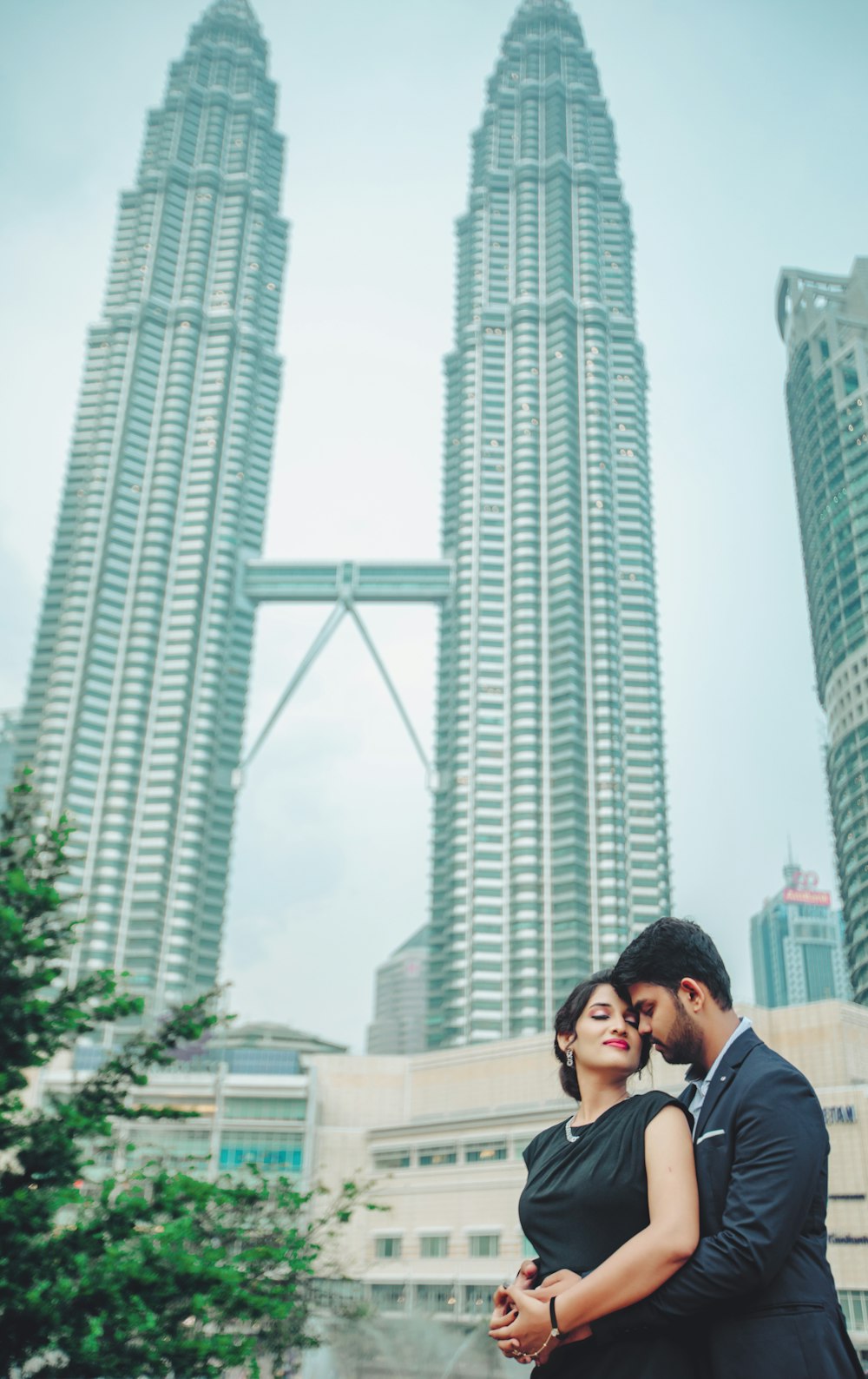 man and woman standing near Petronas Tower, Malaysia