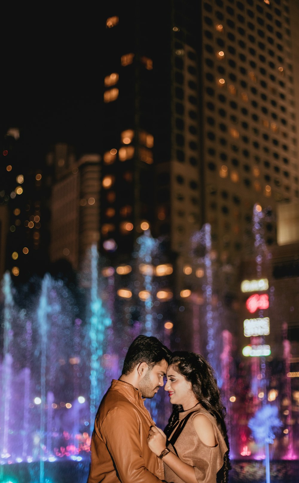 couple standing near water fountain