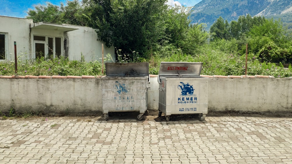 two gray containers near trees