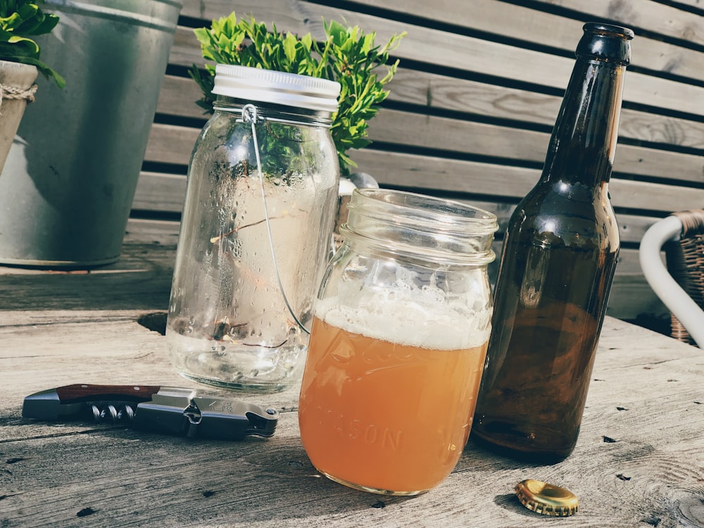 beer in clear glass mason jar on table