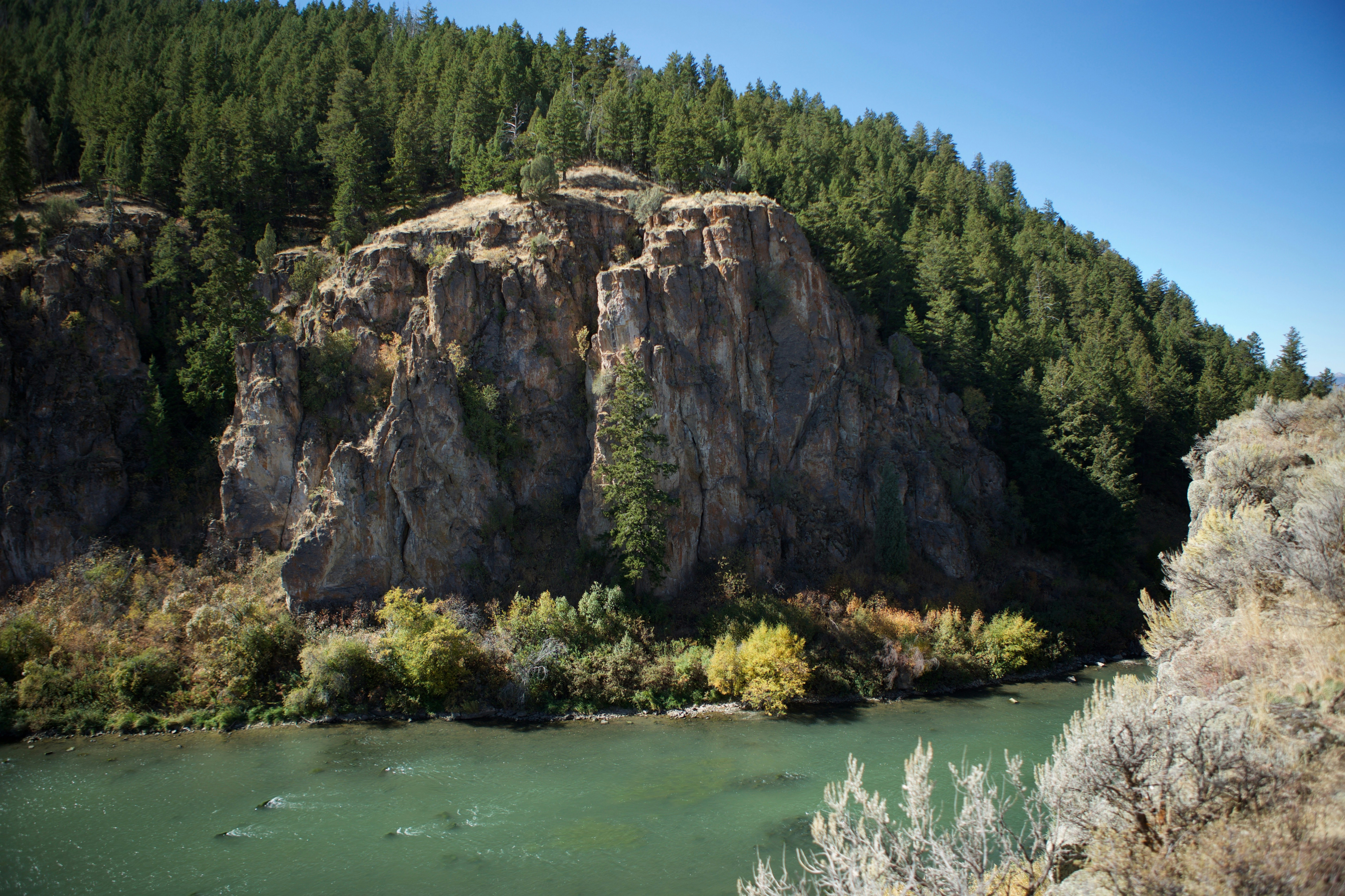 Basalt cliff seen here was noted in journals by early explorer John C Fremont. Bear River, seen at left, flows northward from Bear Lake on the Utah-Idaho border, wraps the tip of the mountain seen here, then turns south and west before emptying into the Great Salt Lake. This is the Great Basin - west of the Continental Divide, but no water reaches the Pacific Ocean. Just beyond this point, the California Trail parts southwest while the Oregon Trail continues northwest. This is the northern terminus of Wasatch Mountains.