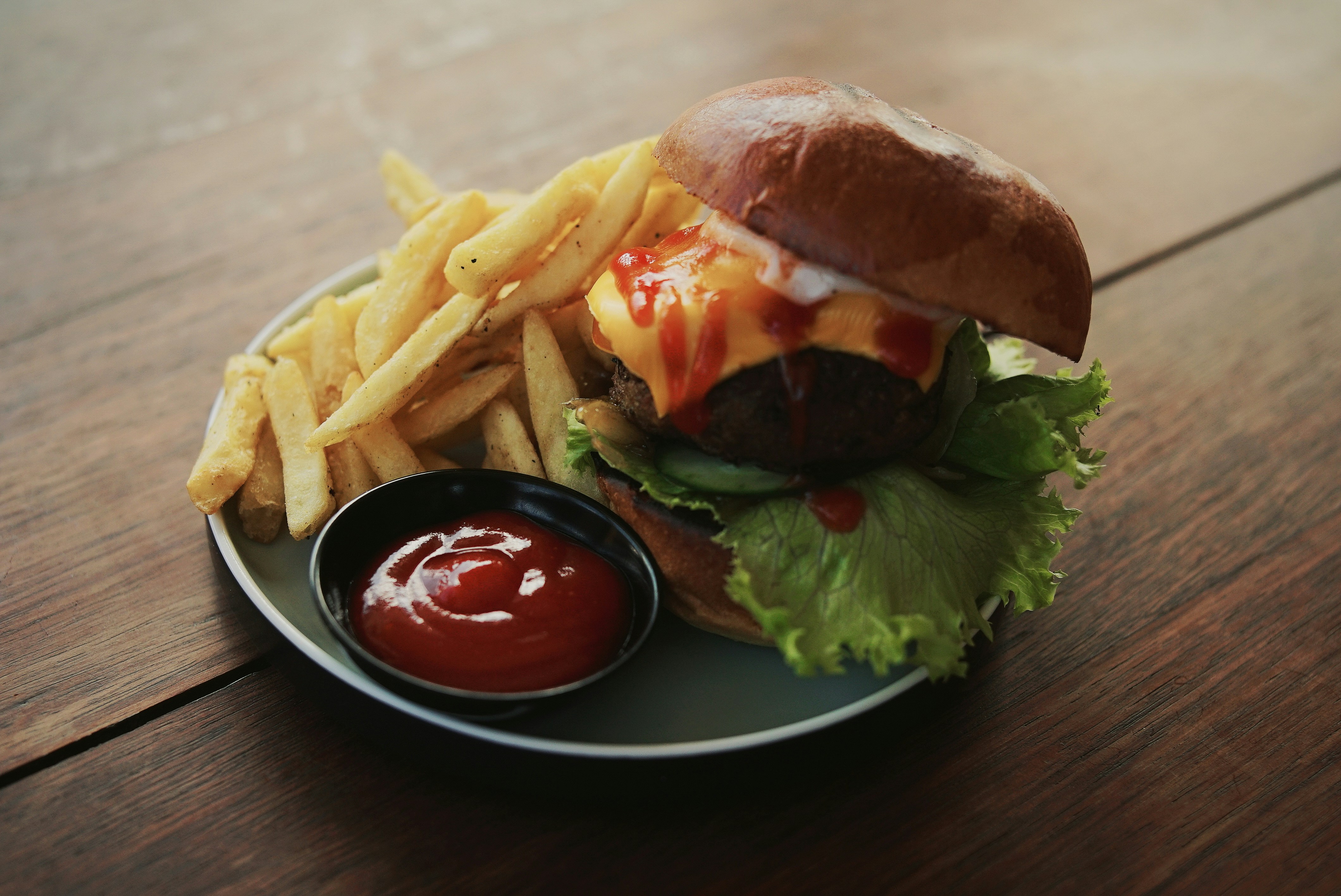 burger and fries with ketchup served on plate