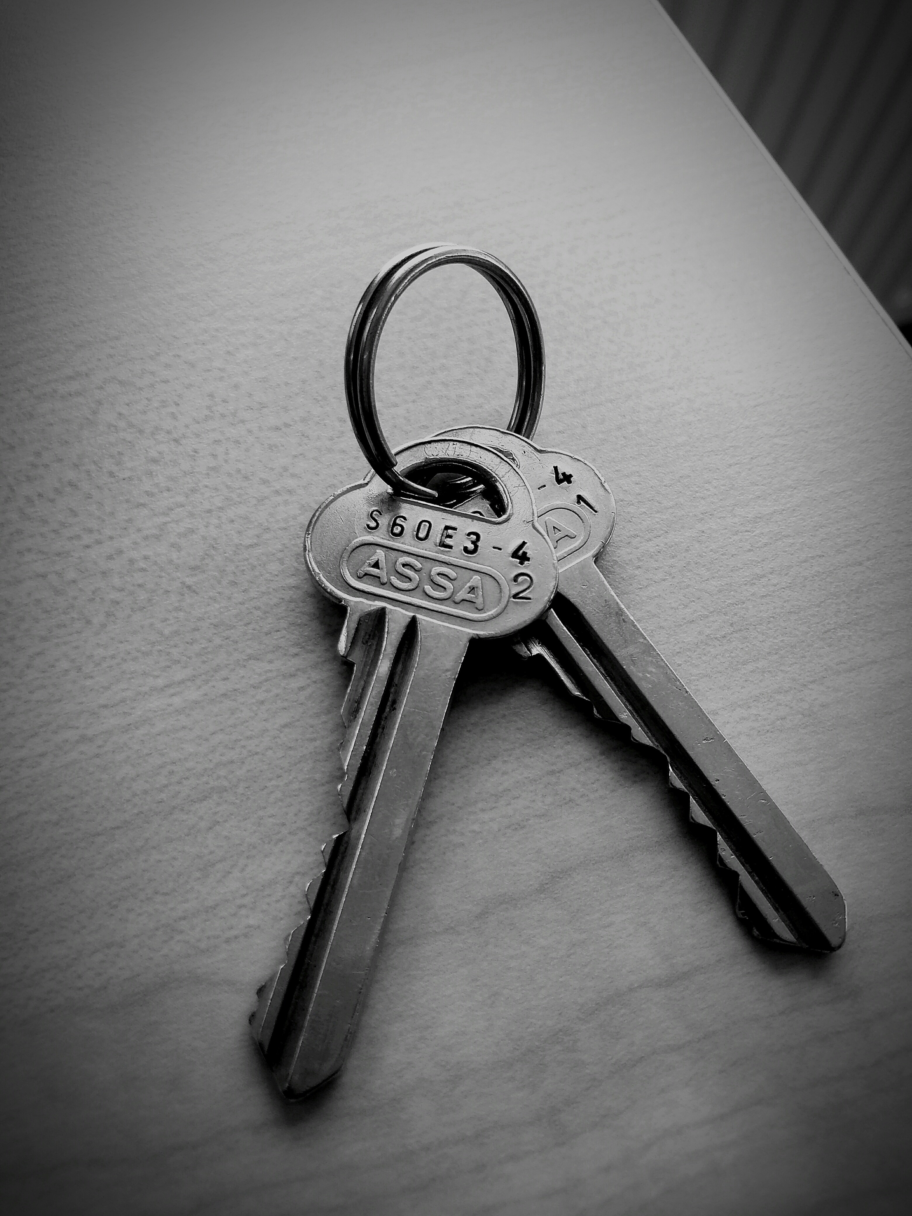 two gray keys on white surface