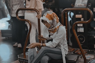 woman seated on arcade machine