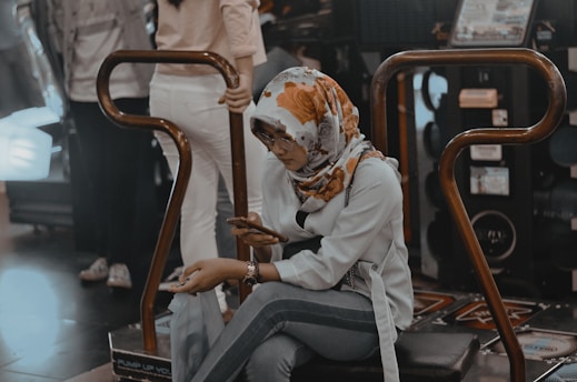 woman seated on arcade machine