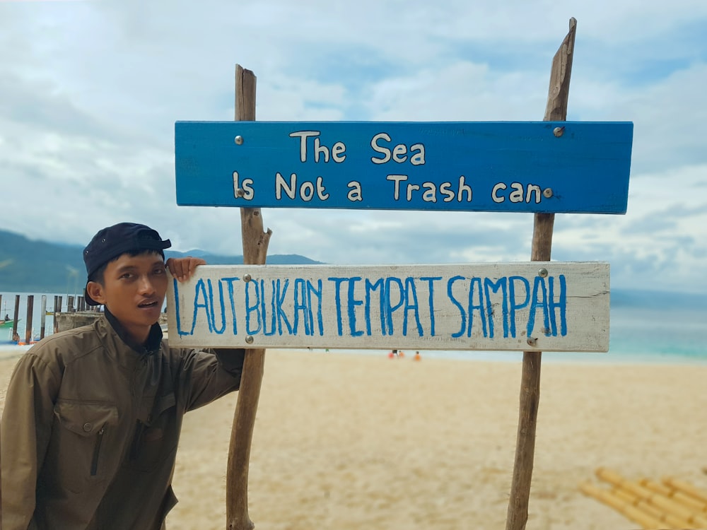 man next to signage