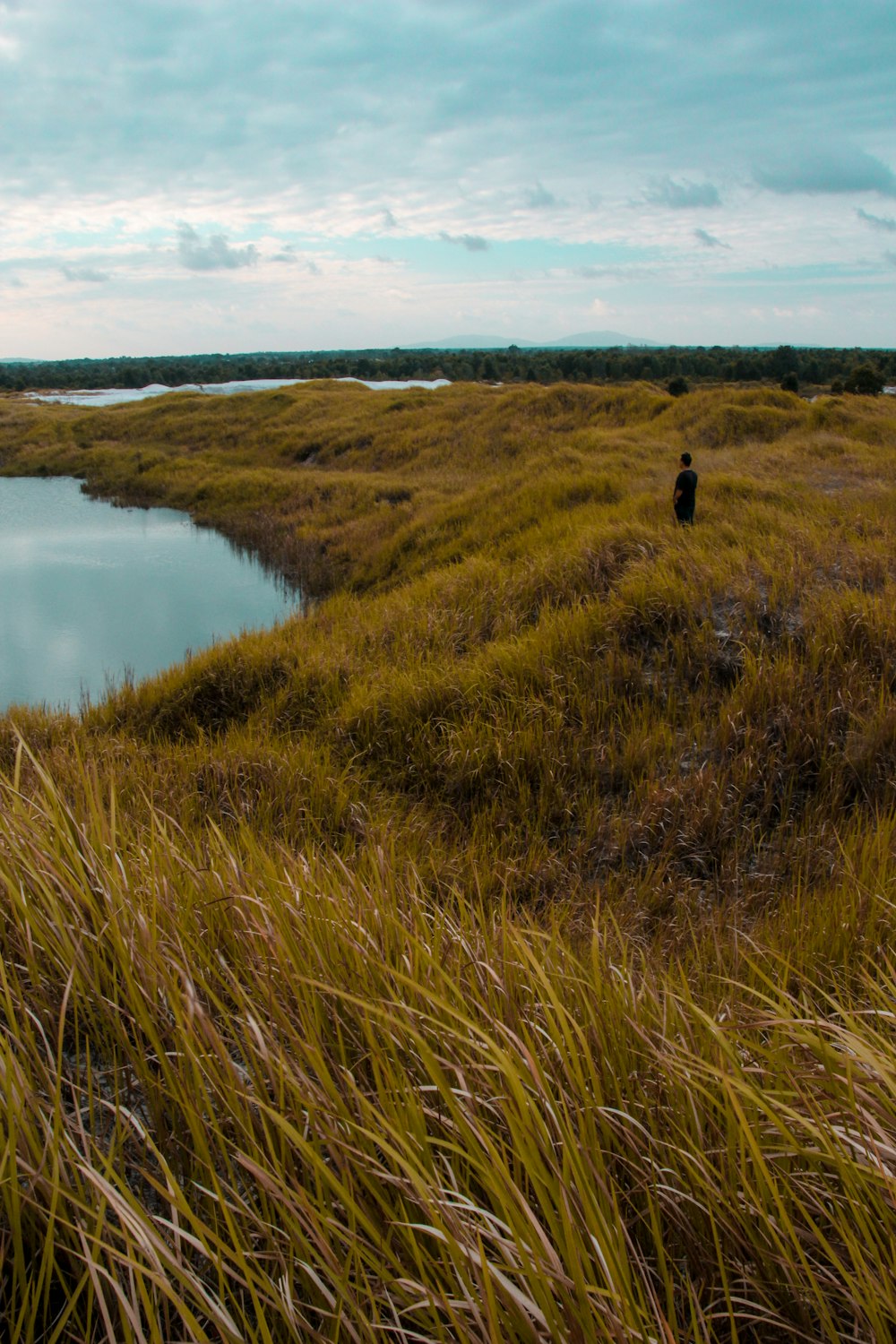 man standing near body of water