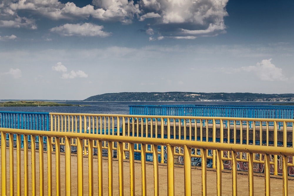 yellow metal railings at the dock during daytime