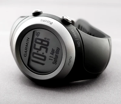 Close-up shot of a stopwatch and red-accented performance metrics on a sleek digital screen.