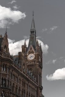 brown concrete clock tower during daytime