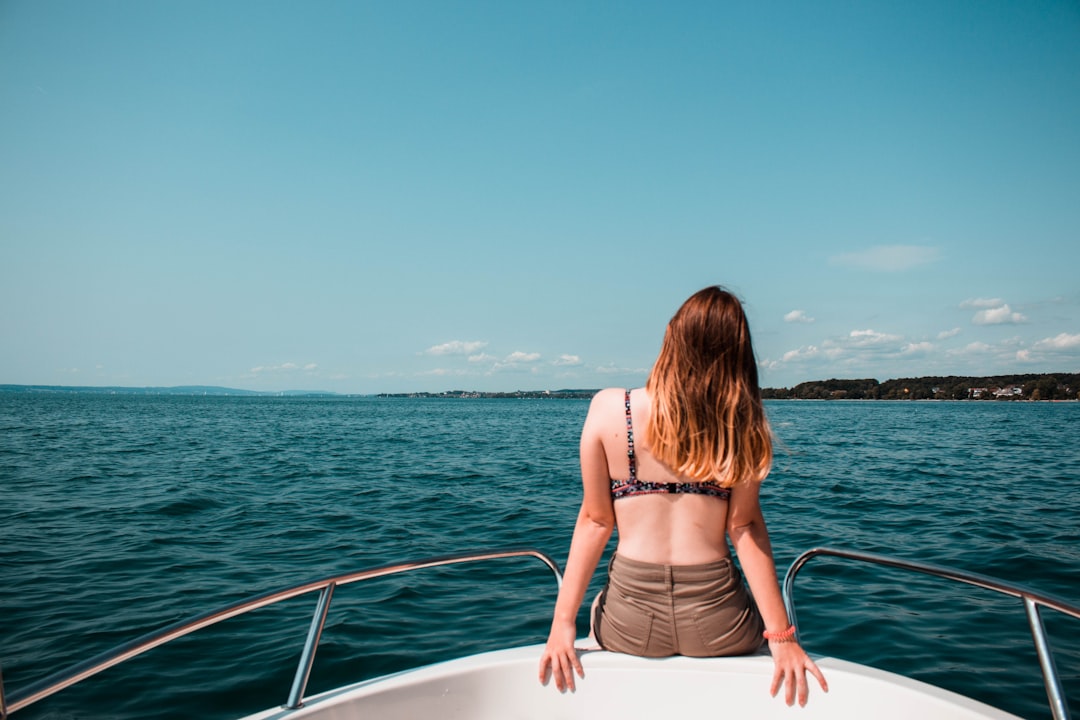 woman seated on boat dock