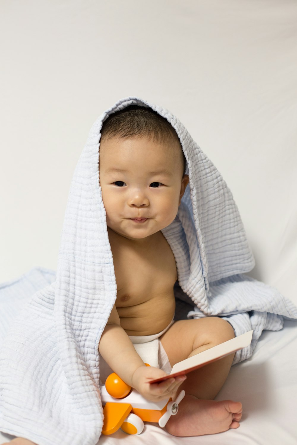 baby wearing blue blanket