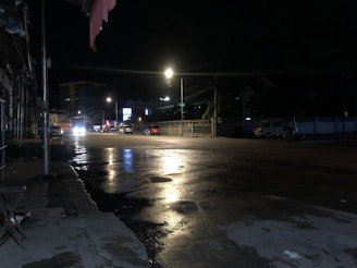Night vision CCTV footage showing a quiet street in Gorontalo