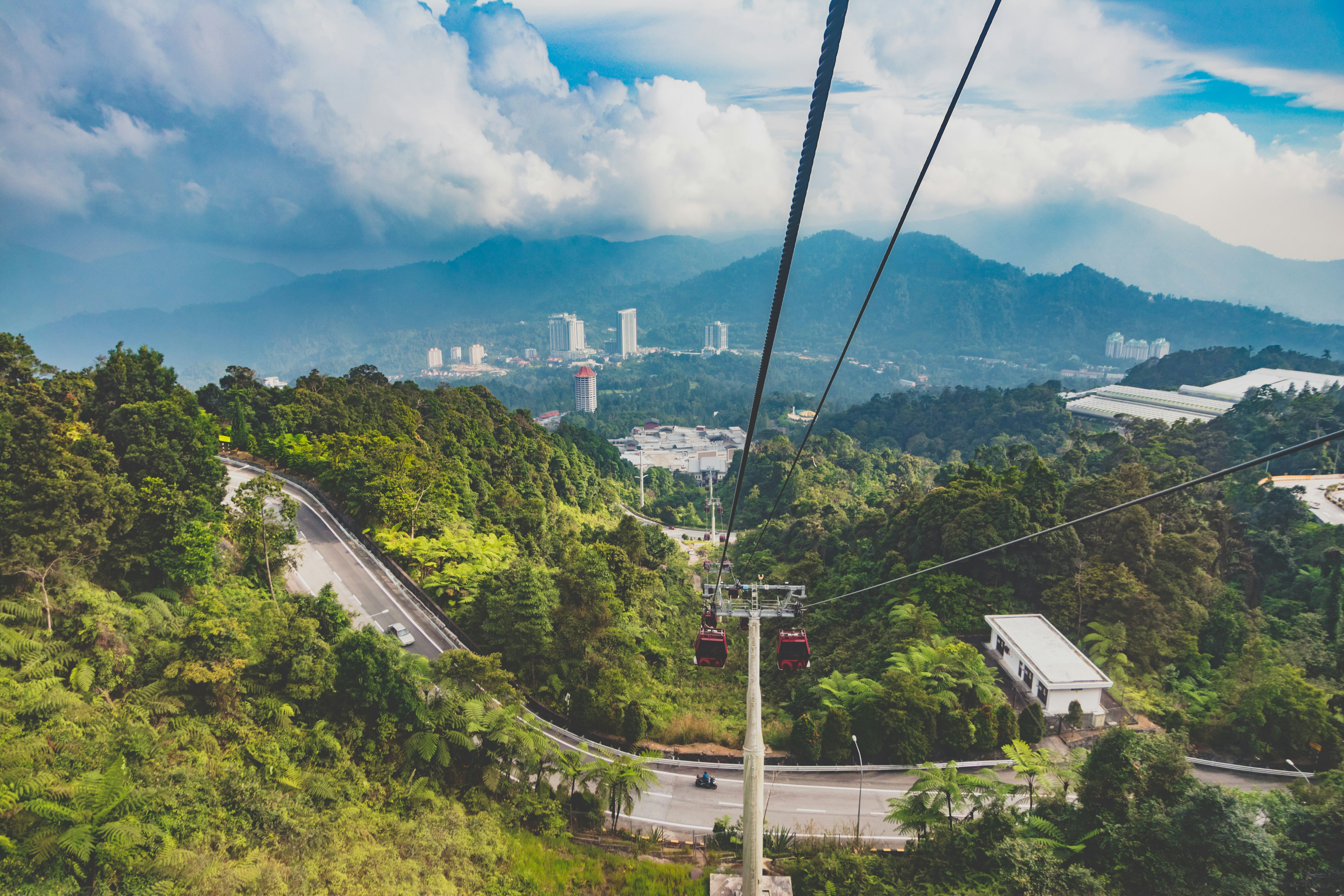 Awana SkyWay cable car in Genting Highlands Malaysia rising through mist to hilltop resort