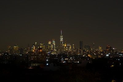 A sleek dark-toned image of a city skyline at night symbolizing financial growth.