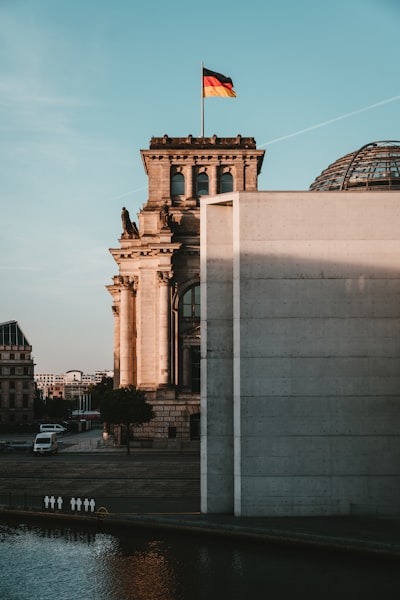 brown concrete building with flag on top during daytime