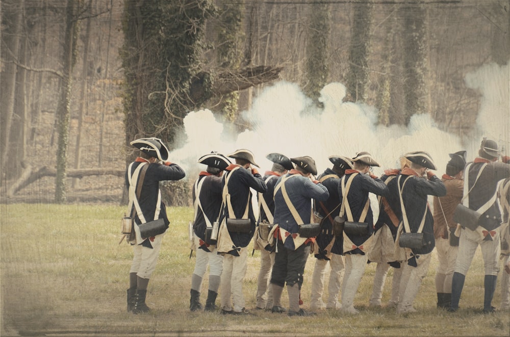 people firing rifle during daytime