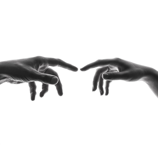 two person's connecting fingers