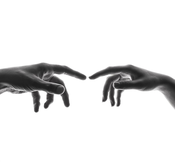 two person's connecting fingers