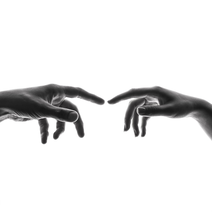 An image of two hands with their index fingers reaching out and almost touching