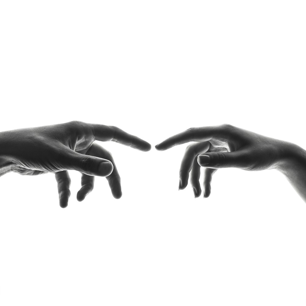 two person's connecting fingers