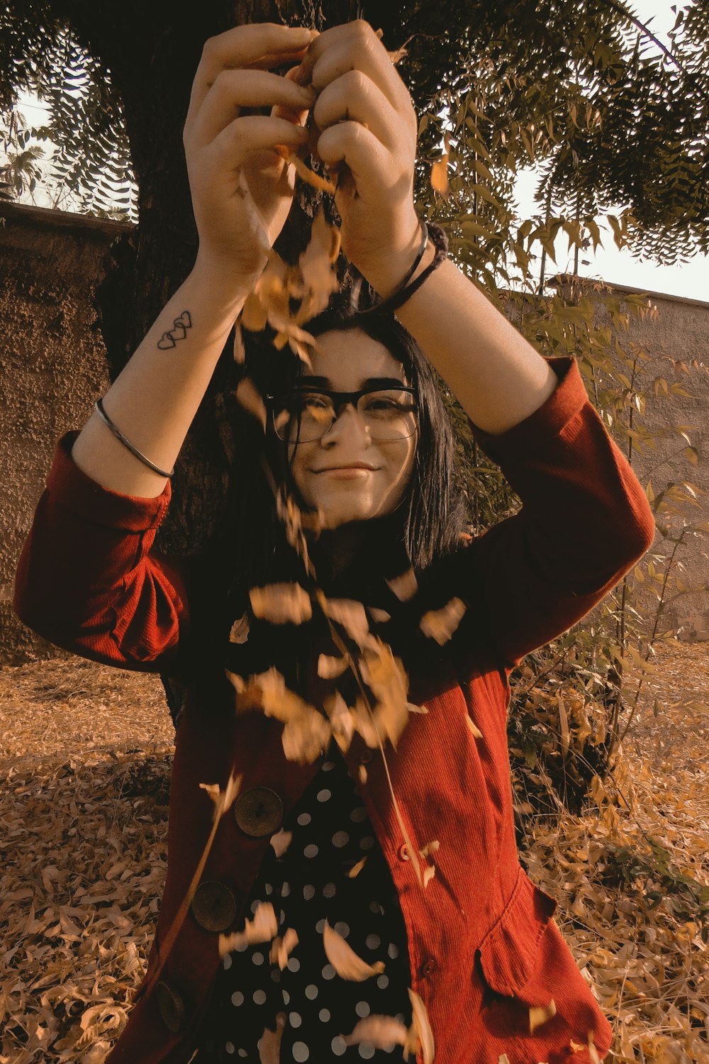 smiling woman holding leaves