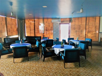 Cozy Mediterranean restaurant interior with blue and white decor and golden accents.