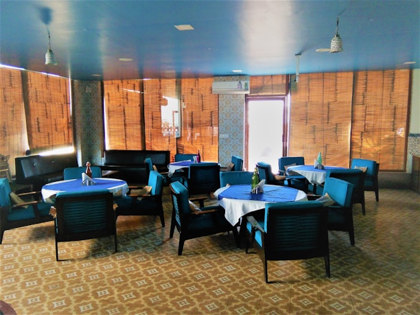 Cozy Mediterranean restaurant interior with blue and white decor and golden accents.